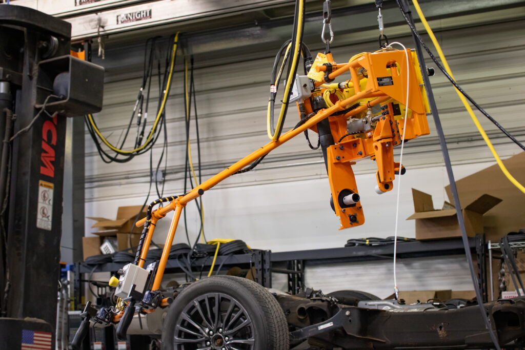 Orange machine hanging from the ceiling in a warehouse